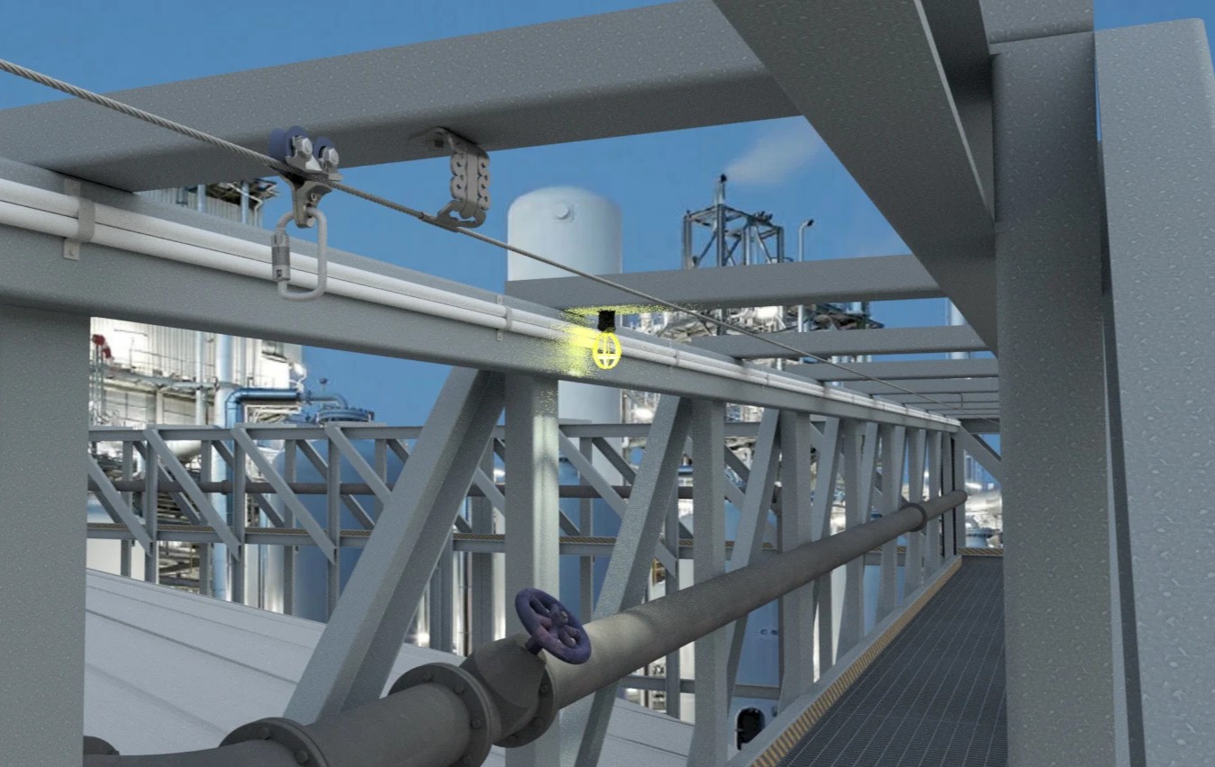 Overhead fall protection system on a structural beam at an oil and gas refinery, with a safety shield icon