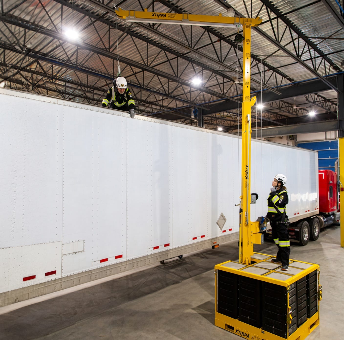 Xtirpa XLT counterweight mast and davit providing overhead fall protection beside a truck trailer.